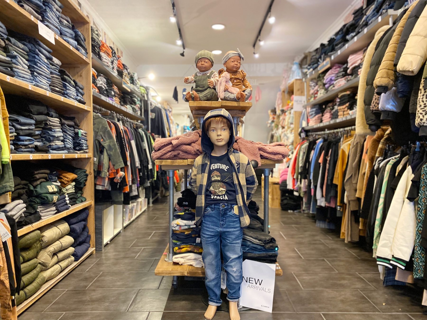 De winkel van Chico & Chica: kasten vol jeans, rekken met jassen en poppen in de nieuwe collectie